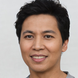 Joyful asian young-adult male with short  black hair and brown eyes