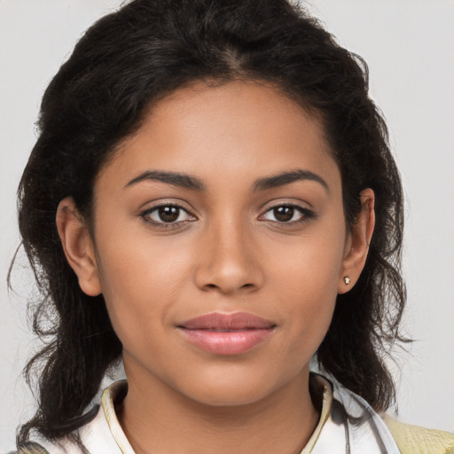 Joyful latino young-adult female with long  brown hair and brown eyes