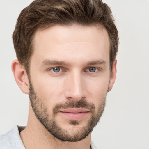 Joyful white young-adult male with short  brown hair and grey eyes