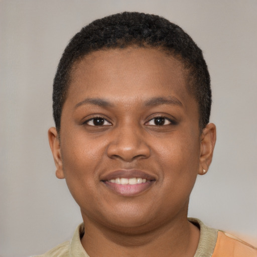 Joyful black young-adult female with short  brown hair and brown eyes
