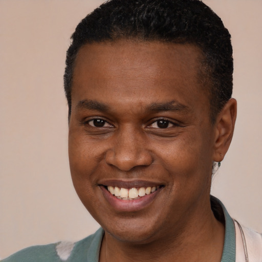 Joyful black young-adult male with short  brown hair and brown eyes