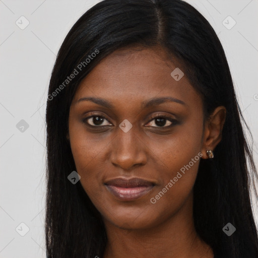 Joyful black young-adult female with long  brown hair and brown eyes
