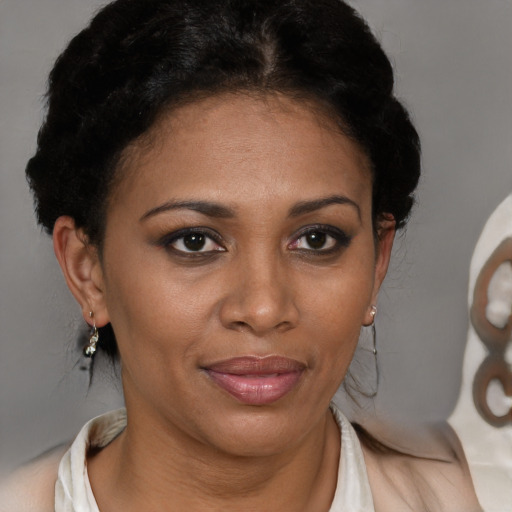 Joyful black adult female with short  brown hair and brown eyes