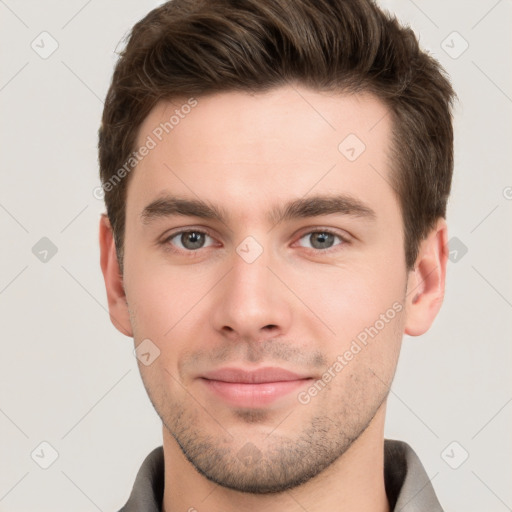 Joyful white young-adult male with short  brown hair and grey eyes