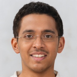 Joyful latino young-adult male with short  brown hair and brown eyes