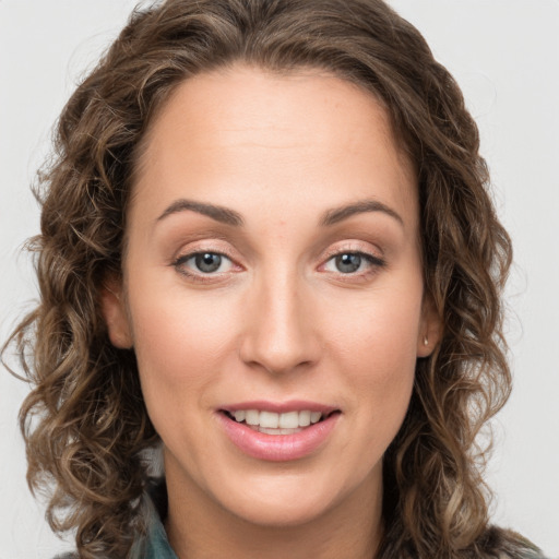 Joyful white young-adult female with long  brown hair and green eyes