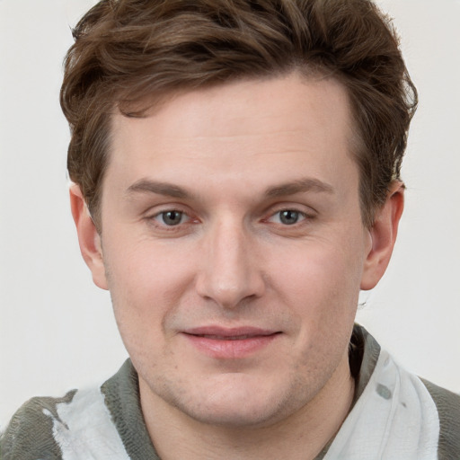 Joyful white adult male with short  brown hair and grey eyes