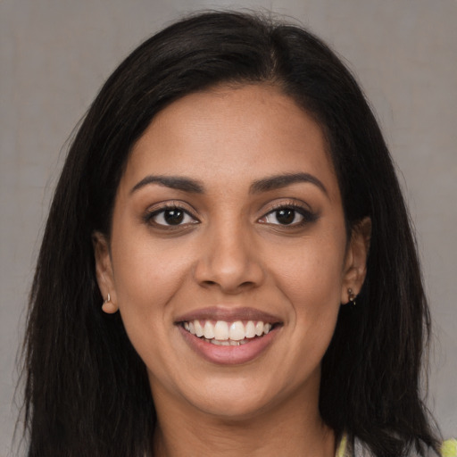 Joyful latino young-adult female with long  black hair and brown eyes