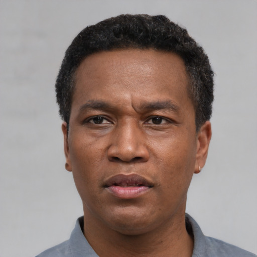Neutral latino adult male with short  black hair and brown eyes