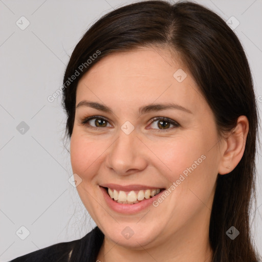 Joyful white young-adult female with long  brown hair and brown eyes