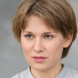 Joyful white adult female with medium  brown hair and grey eyes