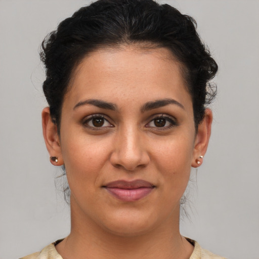 Joyful latino young-adult female with short  brown hair and brown eyes