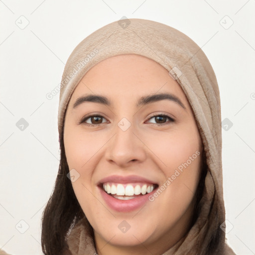 Joyful white young-adult female with long  black hair and brown eyes