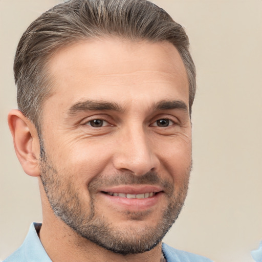 Joyful white adult male with short  brown hair and brown eyes