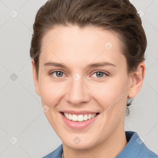 Joyful white young-adult female with short  brown hair and grey eyes