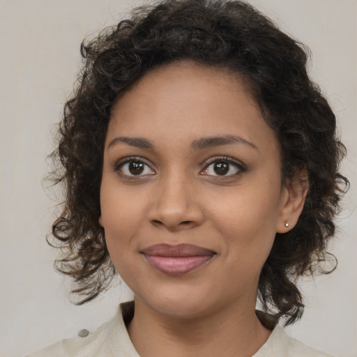 Joyful black young-adult female with medium  brown hair and brown eyes