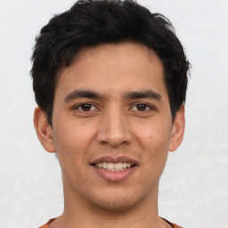 Joyful asian young-adult male with short  brown hair and brown eyes