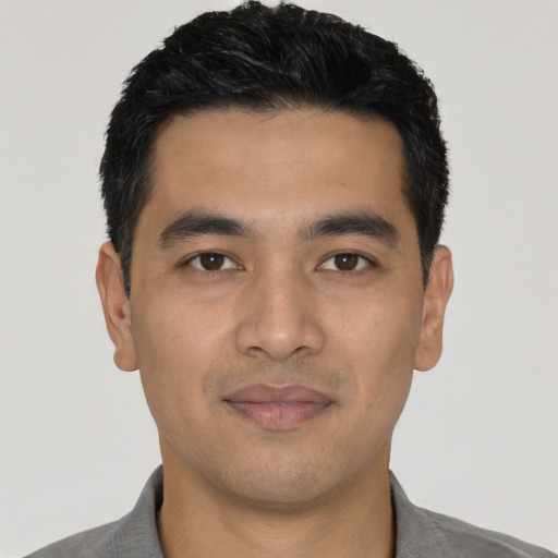 Joyful asian young-adult male with short  black hair and brown eyes