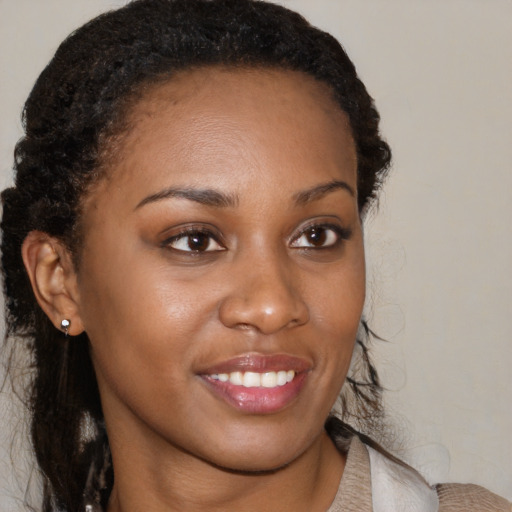 Joyful black young-adult female with medium  brown hair and brown eyes
