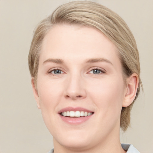 Joyful white young-adult female with medium  brown hair and blue eyes