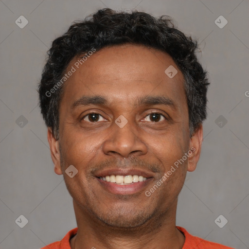 Joyful black adult male with short  brown hair and brown eyes