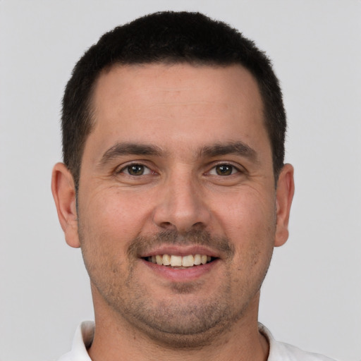 Joyful white young-adult male with short  brown hair and brown eyes