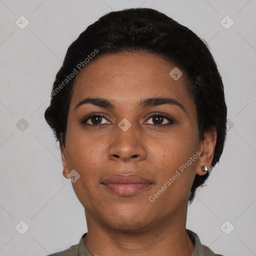 Joyful black young-adult female with short  black hair and brown eyes