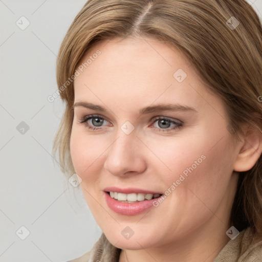 Joyful white young-adult female with medium  brown hair and grey eyes