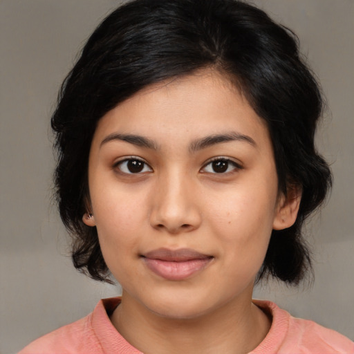 Joyful asian young-adult female with medium  black hair and brown eyes