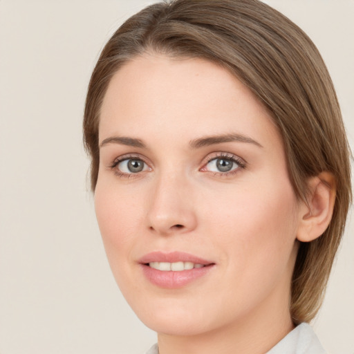 Joyful white young-adult female with medium  brown hair and green eyes