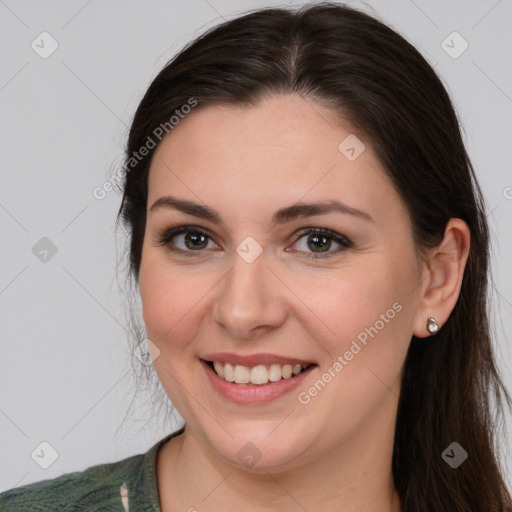 Joyful white young-adult female with long  brown hair and brown eyes