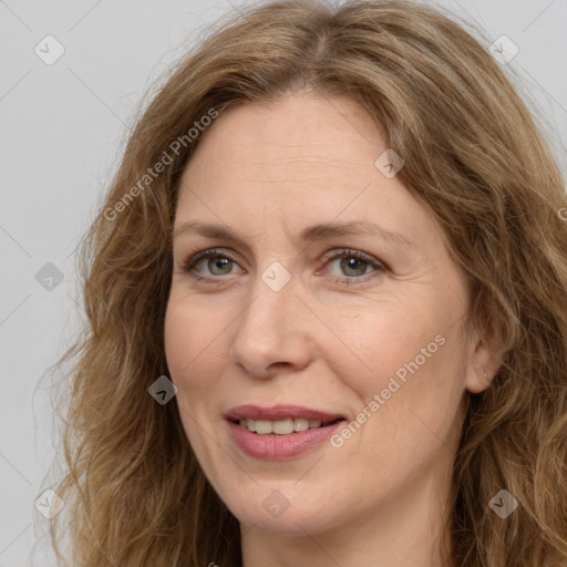 Joyful white adult female with long  brown hair and brown eyes