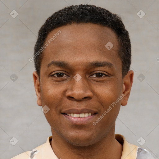 Joyful black young-adult male with short  brown hair and brown eyes