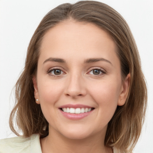 Joyful white young-adult female with long  brown hair and grey eyes