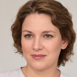 Joyful white young-adult female with medium  brown hair and green eyes