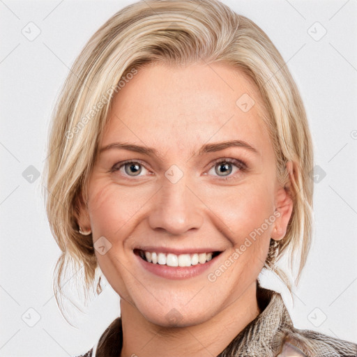 Joyful white young-adult female with medium  brown hair and blue eyes