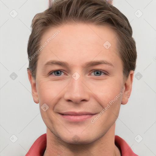 Joyful white young-adult male with short  brown hair and grey eyes