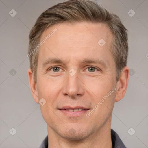 Joyful white adult male with short  brown hair and grey eyes