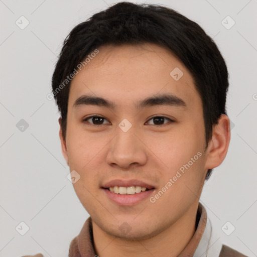 Joyful asian young-adult male with short  brown hair and brown eyes