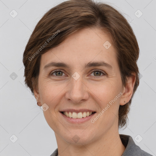 Joyful white adult female with medium  brown hair and grey eyes