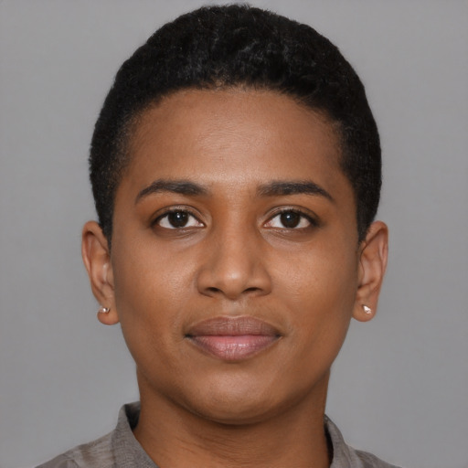 Joyful black young-adult female with short  black hair and brown eyes