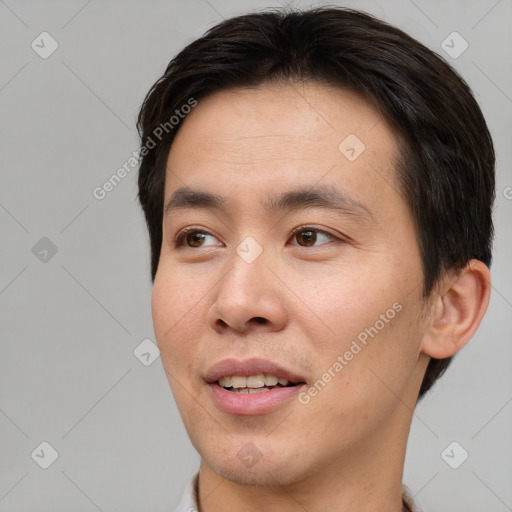 Joyful asian young-adult male with short  brown hair and brown eyes