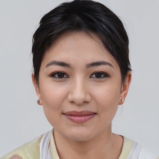 Joyful asian young-adult female with short  brown hair and brown eyes