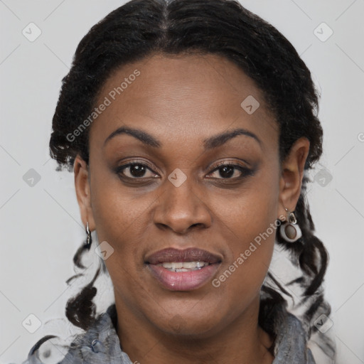 Joyful black adult female with short  brown hair and brown eyes