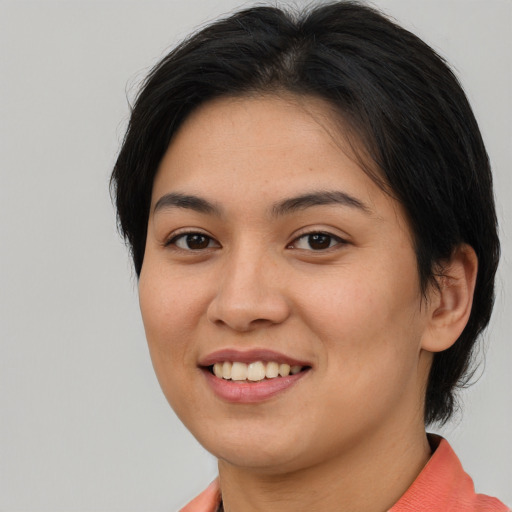 Joyful asian young-adult female with short  brown hair and brown eyes