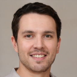 Joyful white young-adult male with short  brown hair and brown eyes