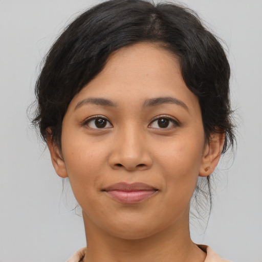 Joyful latino young-adult female with medium  brown hair and brown eyes