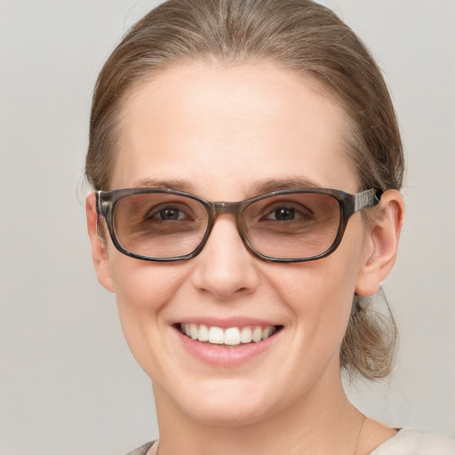 Joyful white young-adult female with medium  brown hair and blue eyes