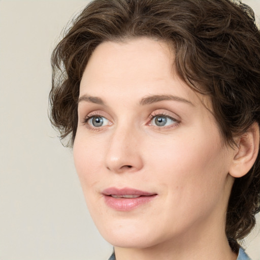 Joyful white young-adult female with medium  brown hair and green eyes