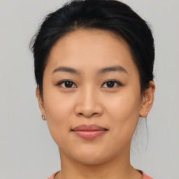 Joyful asian young-adult female with short  brown hair and brown eyes